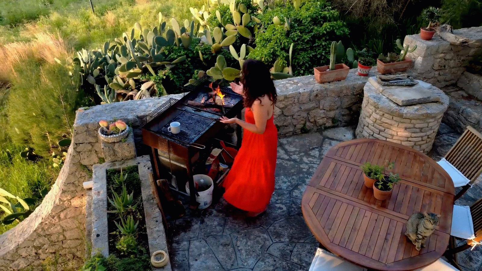 Nikita by the fire on the terrace at Il Sentiero at dusk, Salento